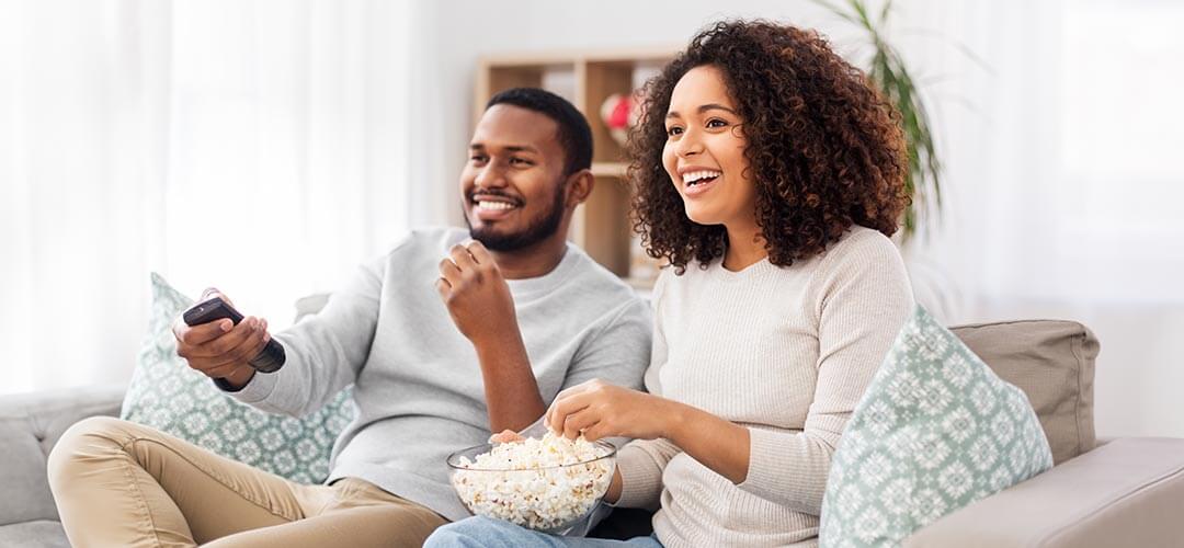 Couple watching TV on couch